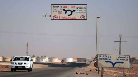 A car drives past an oil installation on the outskirts of In Amenas, deep in the Sahara near the Libyan border.